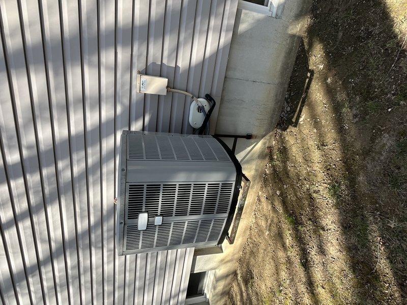 # HVAC Service Report - No Cooling Complaint

Responded to service call for non-operational air conditioning system on residential split system over 10 years old. Upon arrival, performed comprehensive diagnostic evaluation of both indoor air handler unit located in basement mechanical room and outdoor condensing unit positioned on exterior concrete pad.

Conducted visual inspection of indoor equipment, noting furnace/air handler configuration with adjacent water heater installation. Verified proper air filter placement and checked for obvious signs of electrical or mechanical failure. Examined ductwork connections and refrigerant line sets for damage or disconnection.

Proceeded to outdoor unit assessment, checking condensing unit for proper electrical supply at disconnect box. Tested capacitor functionality, contactor operation, and compressor response. Verified fan motor operation and inspected condenser coil condition for blockages or debris accumulation that could restrict airflow 