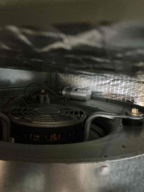 # HVAC Service Report - Cooling System Tune-Up

Completed comprehensive cooling system tune-up on residential air conditioning unit (under 10 years old) located in backyard area. Performed standard maintenance protocol including system inspection, filter evaluation, and operational testing to ensure optimal performance for the cooling season.

## Service Activities Performed

**System Inspection & Component Check:**
- Conducted visual inspection of outdoor condensing unit and associated components
- Examined refrigerant lines and insulation integrity
- Inspected electrical connections and wiring for signs of wear or damage
- Verified proper mounting and structural stability of unit

**Filter Assessment:**
- Evaluated air filter condition (EZ Flow/Flanders brand with honeycomb pattern design)
- Documented filter media appearance showing teal-colored fibrous material
- Noted filter operational status for maintenance records

**Mechanical Components:**
- Inspected compressor assembly and 