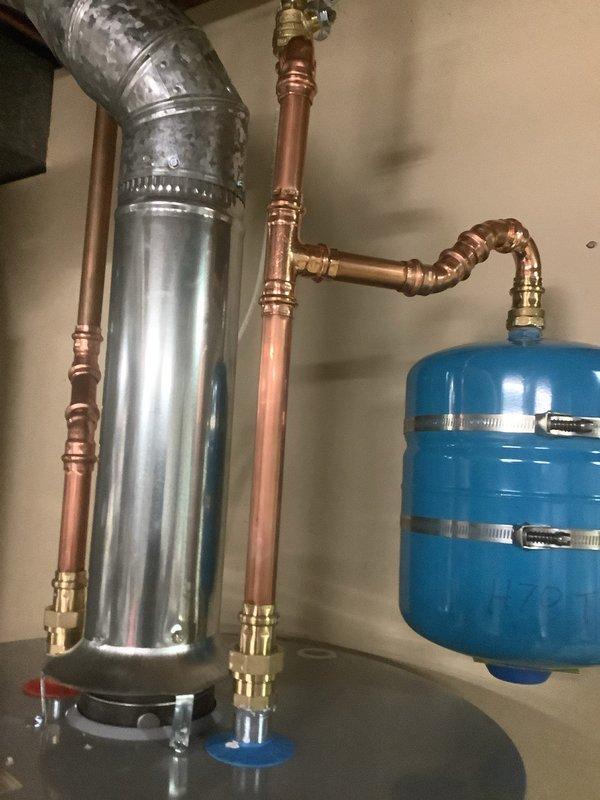 # Service Report: Tanked Water Heater Installation

Successfully installed a 50-gallon tall gas water heater in accordance with permit #26PLU-05390. The installation included complete plumbing connections with copper piping, brass shutoff valves, expansion tank integration, and proper venting with galvanized ductwork. All components were secured to code specifications, pressure tested for leaks, and left in full operational condition with the permit sticker applied as required.