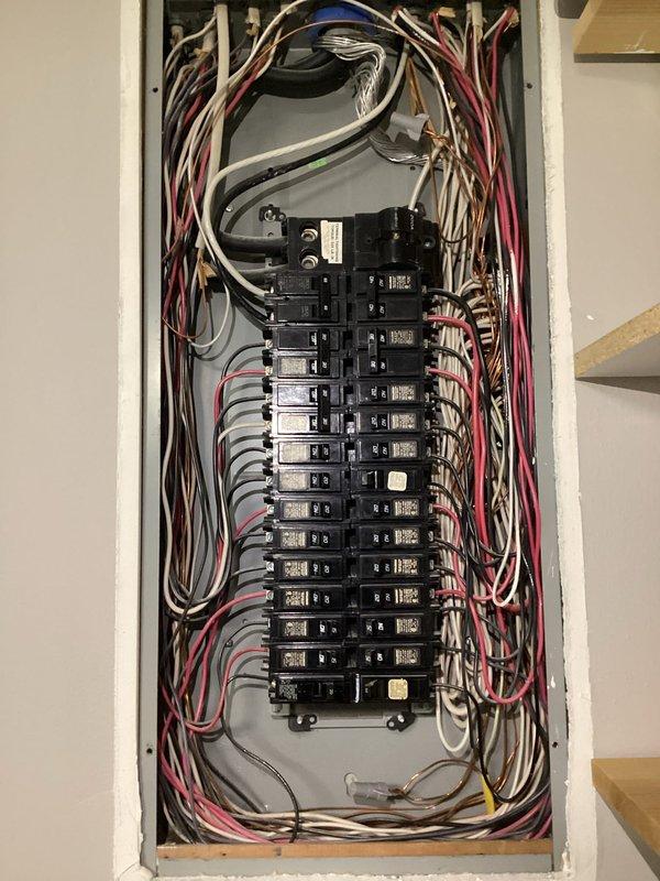 # Electrical Maintenance - Home Audit Summary

Performed complimentary electrical system inspection as part of membership benefits program. Conducted comprehensive evaluation of main electrical panel, verifying proper breaker operation, wire connections, and circuit labeling integrity. Documented panel configuration with detailed photography showing dual-column breaker arrangement with approximately 20-24 circuits, color-coded wiring (including phase conductors, neutrals, and grounding), and existing circuit directory posted on panel door.

Inspection revealed generally organized wiring with proper bundling of neutral and hot conductors throughout the enclosure. Verified all breaker connections were secure and panel components showed no visible signs of overheating, corrosion, or damage. Noted handwritten circuit notes posted adjacent to panel for homeowner reference. All findings documented photographically for service records, with no immediate safety concerns or code violations iden