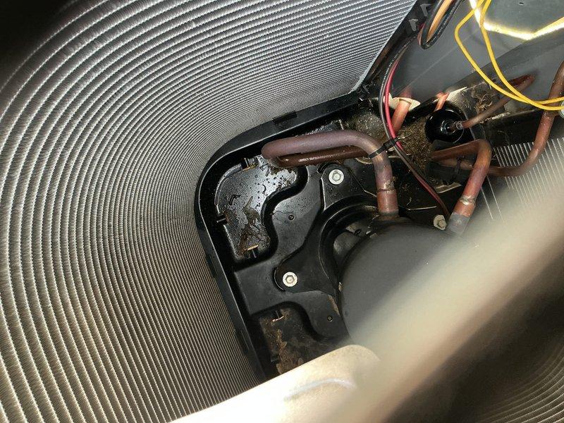 # Service Completion Summary

Responded to no cooling complaint on 3-year-old York residential cooling system. Upon arrival, confirmed unit was running but delivering warm air to occupied space. Performed diagnostic inspection of outdoor condensing unit and indoor evaporator coil assembly.

Visual inspection of evaporator coil revealed significant dust and debris accumulation on fin surfaces, restricting airflow and reducing heat transfer efficiency. Examined refrigerant line connections at both indoor and outdoor units, noting normal copper oxidation consistent with equipment age but no visible signs of refrigerant leakage or oil residue at connection points. Verified electrical connections at coil assembly were secure with proper wire routing through mounting brackets.

Inspected outdoor unit refrigerant lines where they penetrate building exterior, confirming proper insulation coverage and secure mounting to wall surface via rubber-isolated brackets. All copper refrigerant tubing sh