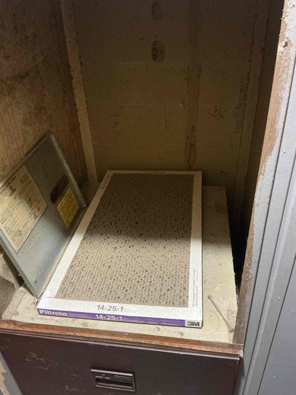 # Service Report: No Cool Call - Residential Mobile Home

Responded to no cooling complaint at residential mobile home. Upon arrival, performed diagnostic evaluation of AC system. Inspected outdoor condensing unit and found extensive corrosion and deterioration of internal components, including compressor assembly, refrigerant lines, and electrical connections. Unit exhibited significant rust and oxidation damage throughout cabinet and internal framework, indicating prolonged exposure to elements and end of service life.

Accessed indoor air handler compartment and inspected air filtration system. Located 14x25x1 Filtrete filter in return air housing. Evaluated airflow pathway and internal ductwork connections within wooden cabinet structure.

Based on comprehensive system assessment, outdoor unit displayed multiple component failures due to severe corrosion and age-related deterioration. Equipment condition deemed beyond economical repair. Documented equipment condition with photograp