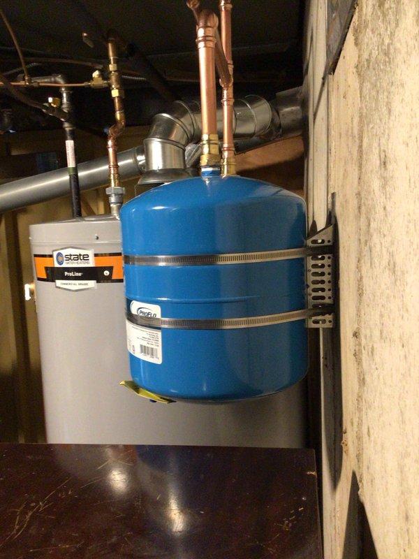 # Plumbing Install - Tanked Water Heater

## Job Description

Completed installation of a 75-gallon tall gas water heater in basement utility area. Technicians acquired unit from supply house and gathered necessary materials including ProPress fittings and copper connections. Installation included proper connection of copper supply lines with brass fittings, mounting and connection of blue expansion tank with secure metal hose clamps, and integration with existing plumbing infrastructure. All connections were made to manufacturer specifications using professional-grade materials and fittings. Black flexible gas line was installed and connected per code requirements. Installation was performed under permit 26PLU-05362 with proper identification sticker applied to unit. System was tested for proper operation, pressure settings verified, and all connections inspected for leaks. Installation meets current plumbing code requirements and manufacturer warranty specifications.