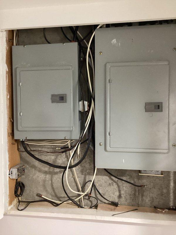 Completed comprehensive electrical safety inspection of residential service panels and distribution system. Documented dual-panel configuration with main breaker assembly and branch circuit distribution, verified proper circuit labeling including dedicated circuits for HVAC unit, well pump, kitchen appliances, and general lighting/receptacle loads. Photographed panel interior showing circuit organization and existing handwritten/printed circuit directory for homeowner reference and future maintenance planning.