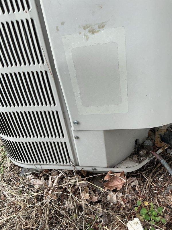 # HVAC Service Completed

Responded to no-cool call for residential condensing unit that would not turn on and was producing unusual noise. Upon arrival, found outdoor unit with significant debris accumulation around base and perimeter, including dried leaves, twigs, and organic matter that had collected against cabinet and restricted airflow. Inspected condensing unit exterior, noting weathered cabinet with dirt buildup and signs of age. Cleared debris from around unit base and checked electrical connections at outdoor disconnect. Verified unit specifications and documented existing conditions with photos showing plumbing connections, cabinet condition, and debris accumulation. Unit required cleaning and further diagnostic evaluation to determine cause of reported strange noise and failure to start. Recommended thorough coil cleaning and electrical component testing to restore proper operation.