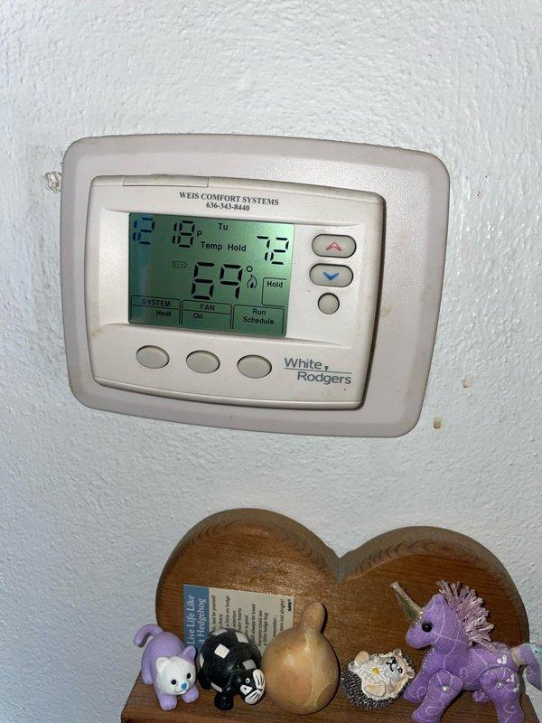 # HVAC Service Call - No Heat Complaint

Responded to a no heat complaint on a 2-year-old Lennox furnace located in basement. Upon arrival, found White-Rodgers thermostat displaying error code E12 and reading 99°F while set to 72°F. Error code E12 indicates a flame sensing issue or ignition failure.

Performed diagnostic inspection of furnace system. Verified proper power supply to unit and confirmed thermostat wiring connections were secure. Checked furnace control board for fault indicators. Inspected ignition system components including hot surface igniter and flame sensor. 

Found flame sensor rod heavily coated with carbon buildup, preventing proper flame detection and causing safety lockout. Removed and cleaned flame sensor using emery cloth to restore proper conductivity. Inspected burner assembly and found minor dust accumulation on burners. Cleaned burner surfaces to ensure proper combustion.

Verified proper operation of intake and exhaust PVC venting system with no blockages