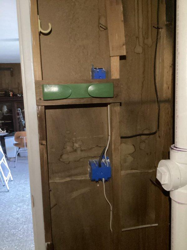 Installed wall switch at room entrance to control existing ceiling fan fixture that previously operated only by pull chain. Ran electrical wiring from fixture location through ceiling/wall cavity to new switch box mounted at entry point. Installed single-pole switch in blue junction box on wall, terminated connections, and tested operation to ensure proper control of ceiling fan from entrance location, eliminating need for pull chain operation.