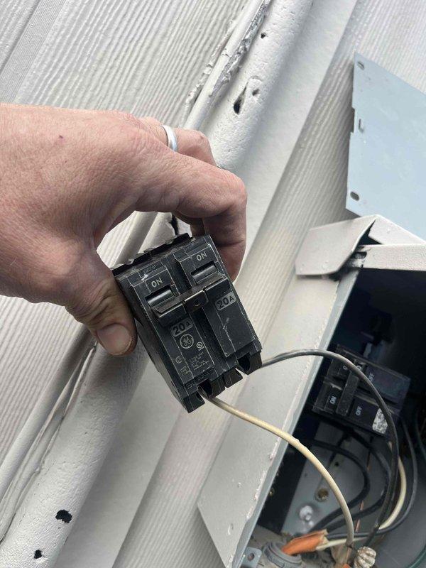 Replaced defective 2-pole 2-amp GE circuit breaker serving mini-split system. Removed failed breaker from electrical panel, installed new breaker, and verified proper electrical connection and operation. System restored to normal heating and cooling function.