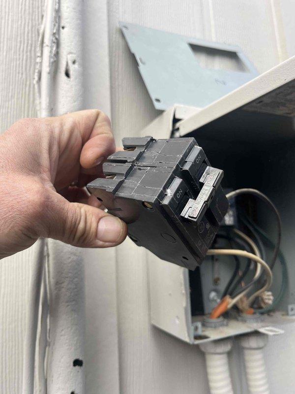 Replaced defective 2-pole 2-amp GE circuit breaker serving mini-split system. Removed failed breaker from electrical panel, installed new breaker, and verified proper electrical connection and operation. System restored to normal heating and cooling function.