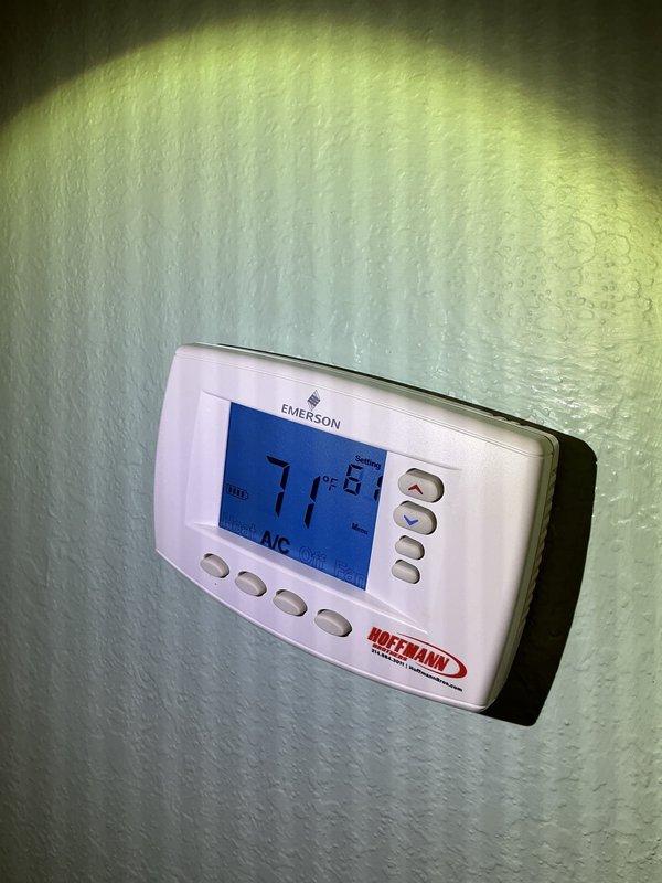 Completed comprehensive cooling season tune-up on geothermal HVAC unit located in interior closet. Performed standard maintenance protocol on 20+ year old packaged system including inspection of blower assembly, refrigerant lines, electrical connections, and filter drier. Verified thermostat operation showing 71°F setpoint in AUTO/AC mode, confirmed all internal components functioning within normal parameters, and system operating efficiently for continued cooling performance.