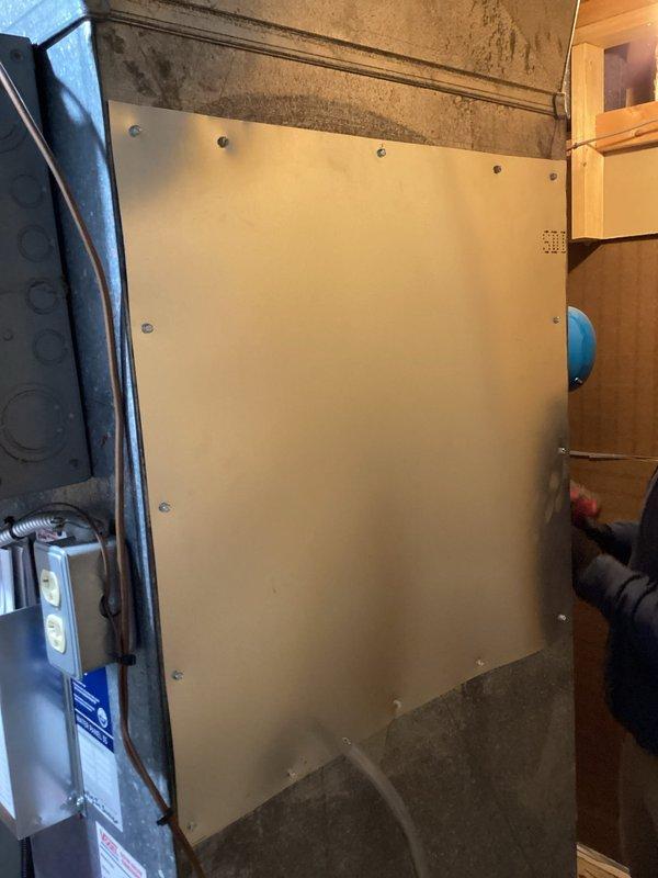 Removed existing humidifier unit from furnace system in basement and fabricated a cover panel to seal the opening left in the furnace cabinet. Secured panel with appropriate fasteners to ensure proper system integrity and prevent air leakage that could affect furnace efficiency and operation.
