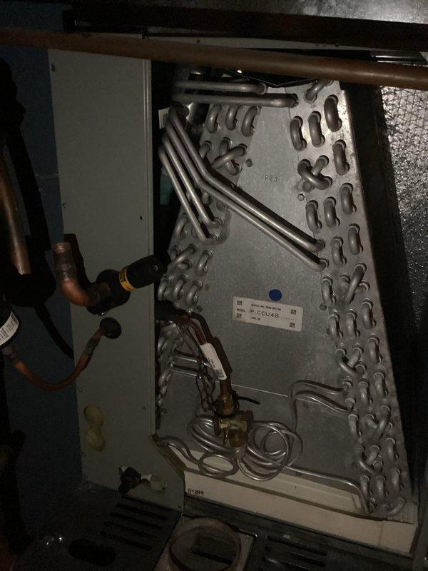 Replaced defective evaporator coil on Trane air handler system. Removed and properly disposed of failed coil assembly, installed new warranty replacement unit, and verified all refrigerant line connections were secure. System tested and confirmed operational with proper airflow restored.