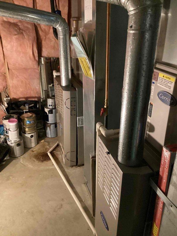 Responded to no cooling complaint on 19-year-old Carrier system. Upon arrival, performed complete system diagnostic including visual inspection of furnace, ductwork, and associated components in basement mechanical room. Evaluated air handler operation, checked refrigerant levels, and inspected condensate drainage system. Verified electrical connections and tested thermostat communication. Assessed overall system performance and identified service needs. Documented equipment condition through photographic evidence showing furnace unit with metallic supply ductwork and associated HVAC infrastructure. Provided customer with findings and recommended solutions to restore cooling functionality to the residential comfort system.