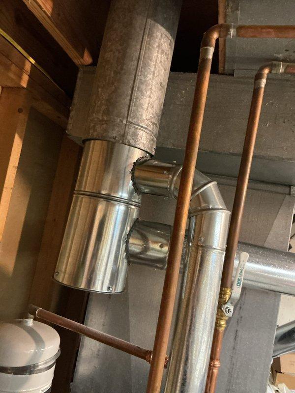 Replaced defective 6x4x3 swivel tee fitting in the ductwork system located in the basement utility area. The old galvanized component showed signs of age and wear, and was removed and replaced with new metallic transition ductwork to restore proper airflow and system function. System tested and confirmed operational for both heating and cooling modes upon completion.