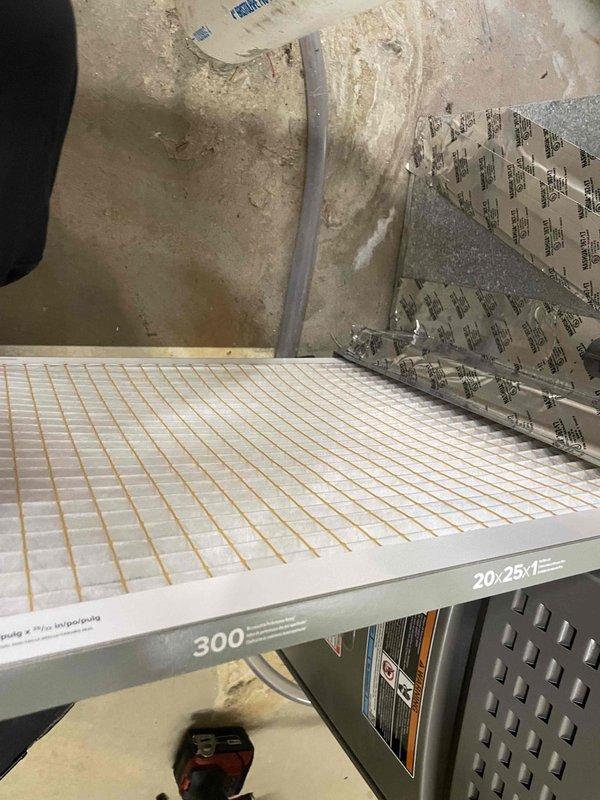 Completed cooling system tune-up on single residential unit located at side of home. Performed comprehensive maintenance including inspection of outdoor condenser unit with cylindrical design and protective mesh grille, verified unit operation and refrigerant levels. Inspected and documented 20x25x1 air filter with MERV 300 rating inside air handler compartment, noting pleated filter condition. System tested and confirmed operational within manufacturer specifications for unit under 10 years of age.