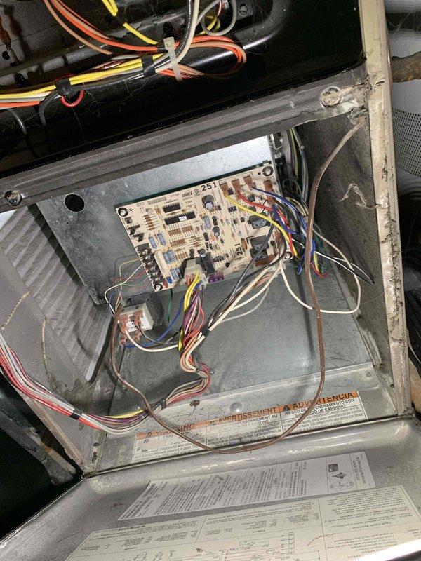 Completed comprehensive tune-up service on a 32-year-old residential air conditioning unit located in backyard under Home Depot service contract. Performed standard maintenance protocol including inspection of electrical control board, wiring connections, and internal components within equipment housing. All systems evaluated and found operational with documentation photos captured of circuit board and internal wiring configuration for service records.