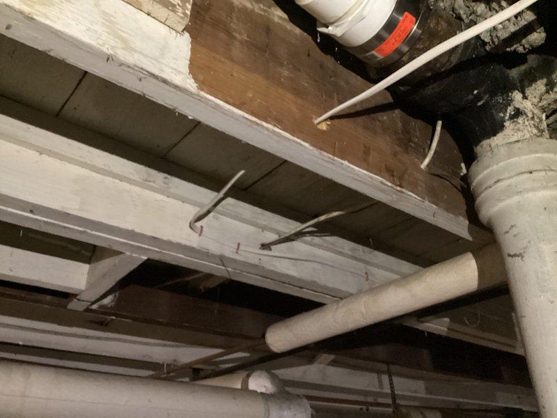 Completed electrical fixture installation at residential property. Technicians arrived on-site and collected payment for previously approved estimate before commencing work. Installation included exterior and interior electrical fixtures with associated wiring and mounting hardware. Exterior work involved proper fixture mounting to building foundation with appropriate weatherproofing and conduit installation. Interior basement installation required routing electrical wiring through floor joists and structural beams, ensuring proper clearances from plumbing lines and maintaining code-compliant spacing. All fixtures were tested for proper operation and electrical connections were verified for safety and functionality. Job site was photographed for documentation purposes upon completion.