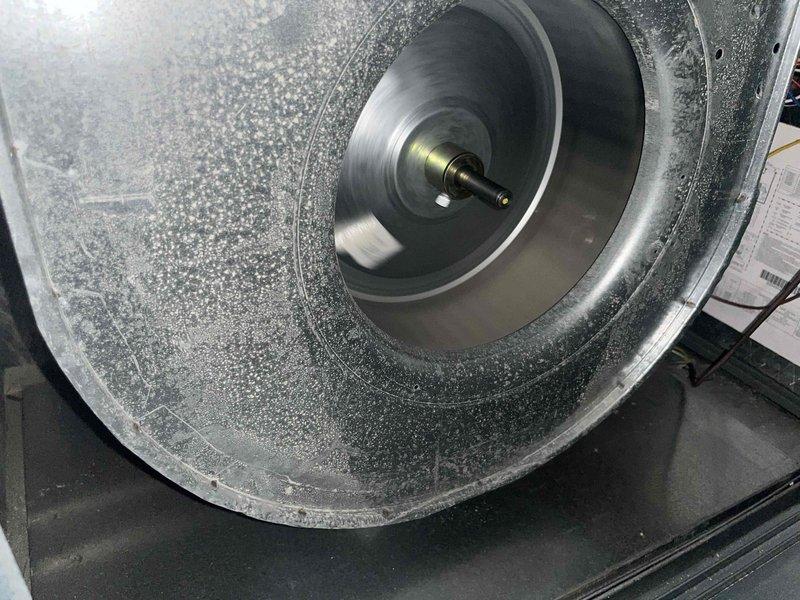 Completed preventive maintenance tune-ups on two residential air conditioning units (2009 and 2018 models). Performed comprehensive system inspections including electrical diagnostics with amp draw measurements on both units, verified proper blower motor operation, and inspected capacitors for functionality. Observed normal condensation patterns on blower assembly indicating adequate system cooling performance during operation.