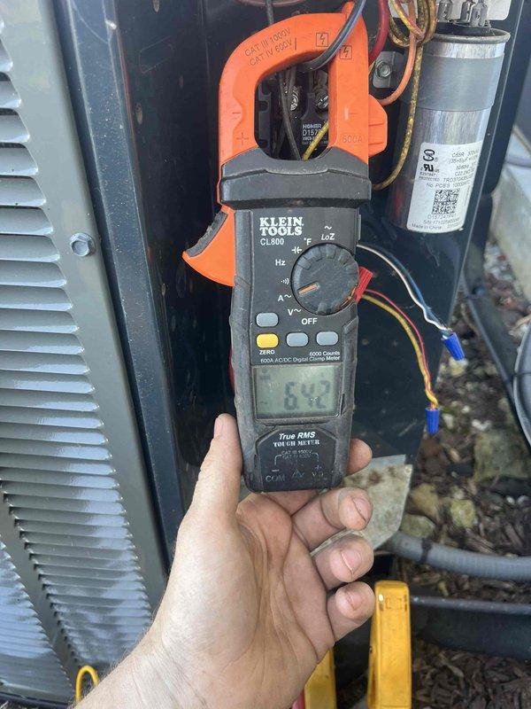 Completed preventive maintenance tune-ups on two residential air conditioning units (2009 and 2018 models). Performed comprehensive system inspections including electrical diagnostics with amp draw measurements on both units, verified proper blower motor operation, and inspected capacitors for functionality. Observed normal condensation patterns on blower assembly indicating adequate system cooling performance during operation.