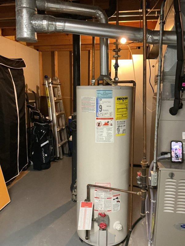 Successfully installed a 50-gallon tall gas water heater in basement utility area. Connected all necessary copper piping, pressure relief valve, and gas line to manufacturer specifications. Verified proper venting and clearances from adjacent HVAC equipment. Applied permit identification sticker per permit #26PLU-05614. Unit tested and operational with all safety controls functioning correctly.