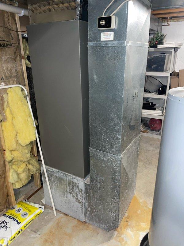 Responded to no-cool complaint on 5-year-old system struggling to maintain setpoint. Upon inspection, found indoor air handler with significant condensation and frost accumulation on lower cabinet section, indicating restricted airflow across evaporator coil. Thermostat displayed 73°F actual temperature with 72°F setpoint in cooling mode. Diagnosed severely restricted airflow due to clogged air filter causing evaporator coil to freeze and reducing system capacity. Replaced dirty air filter with new filter, allowed coil to thaw completely, and verified proper airflow restoration. System cycled properly with adequate cooling capacity and temperature differential upon restart. Advised homeowner on importance of regular filter maintenance to prevent future freeze-ups and capacity issues.