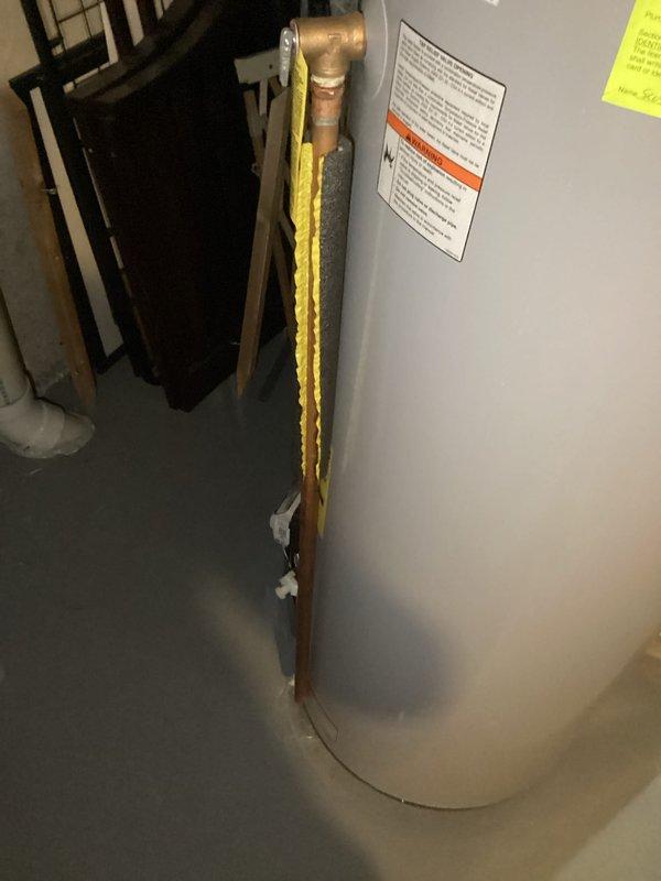 Replaced failed 50-gallon gas water heater in basement that was non-operational and leaking. Installed new unit with proper copper piping connections, drain pan, and safety controls including gas valve assembly and temperature/pressure relief valve. Applied plumbing permit identification sticker per permit #26PLU-05710 and verified all connections for proper operation and code compliance.