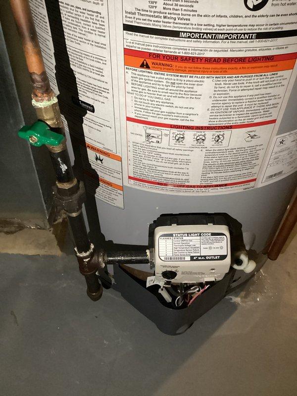 Replaced failed 50-gallon gas water heater in basement that was non-operational and leaking. Installed new unit with proper copper piping connections, drain pan, and safety controls including gas valve assembly and temperature/pressure relief valve. Applied plumbing permit identification sticker per permit #26PLU-05710 and verified all connections for proper operation and code compliance.