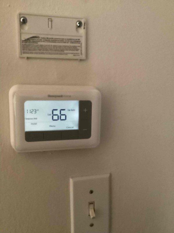Responded to no-cooling call on 12-year-old AC system. Upon arrival, coordinated with customer to ensure presence during diagnostic evaluation. Performed system inspection of Carrier HVAC unit located in basement mechanical room. Evaluated thermostat operation (Honeywell digital unit displaying 66°F at time of inspection) and verified proper power supply to both thermostat and air handler. Conducted visual inspection of furnace/air handler unit and associated ductwork, checking for obvious signs of electrical failure, tripped breakers, or disconnected wiring. Documented equipment conditions with photographic evidence of thermostat settings and mechanical room equipment layout for service records. Given the age of the system and no-start condition, recommended further electrical diagnostics and potential evaluation of compressor functionality at outdoor condensing unit.