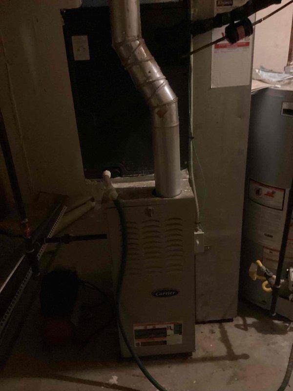Responded to no-cooling call on 12-year-old AC system. Upon arrival, coordinated with customer to ensure presence during diagnostic evaluation. Performed system inspection of Carrier HVAC unit located in basement mechanical room. Evaluated thermostat operation (Honeywell digital unit displaying 66°F at time of inspection) and verified proper power supply to both thermostat and air handler. Conducted visual inspection of furnace/air handler unit and associated ductwork, checking for obvious signs of electrical failure, tripped breakers, or disconnected wiring. Documented equipment conditions with photographic evidence of thermostat settings and mechanical room equipment layout for service records. Given the age of the system and no-start condition, recommended further electrical diagnostics and potential evaluation of compressor functionality at outdoor condensing unit.