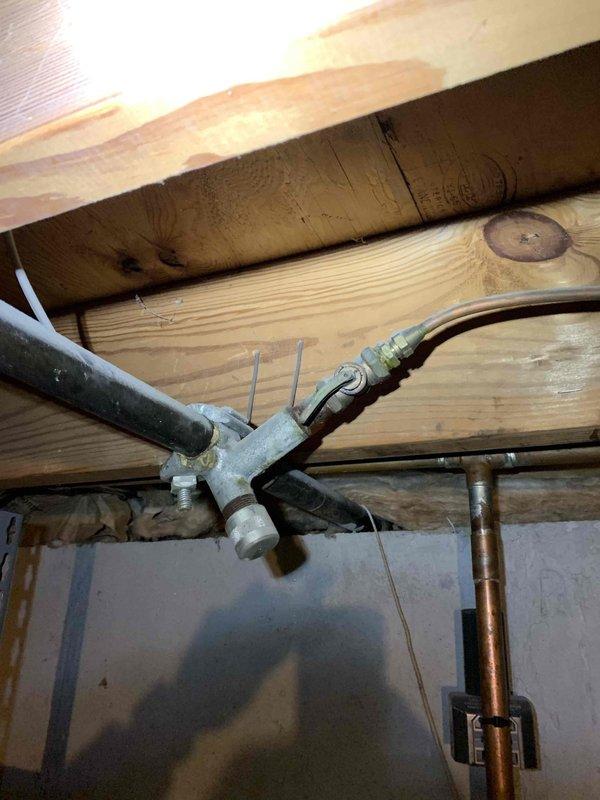 Responded to service call for 14-year-old furnace system located in basement following home inspection report of gas leak and cracked heat exchanger. Upon arrival, performed comprehensive safety inspection of furnace unit and associated gas piping infrastructure. Conducted visual examination of heat exchanger for structural integrity and signs of cracking or failure. Inspected gas supply lines, including black iron piping and copper connections at junction points, checking all fittings and valves for potential leak sources. Documented existing conditions of gas piping system, ductwork connections, and furnace installation via photographs for record purposes. Due to confirmed safety concerns identified during inspection, provided assessment findings and recommendations to address heat exchanger failure and gas leak hazards.