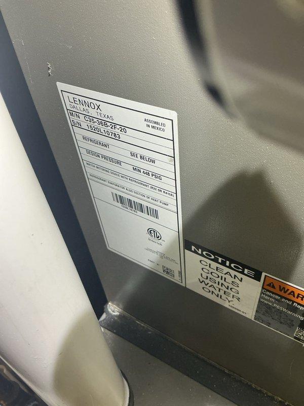 Responded to no-cool complaint on Lennox condensing unit model C25-36B-2-2D located at rear of property. Upon arrival, customer reported air conditioning system blowing warm air. Performed diagnostic evaluation of 10+ year old split system including visual inspection of outdoor condensing unit and indoor air handler components. Documented equipment model and serial number information, assessed overall system condition, and photographed unit nameplate and installation configuration in basement mechanical room. System evaluated and findings discussed with customer for repair recommendations.