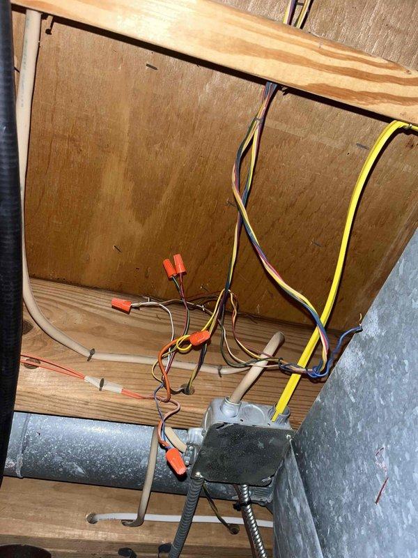 # HVAC Service Call - No Cooling Condition

Responded to service call for residential air conditioning system not cooling. Property has two units, both over 10 years old, located in backyard area. This was a new customer diagnostic service call.

## Work Performed

Upon arrival, conducted visual inspection of outdoor condensing units. Accessed indoor air handler compartment and inspected electrical connections, blower motor assembly, and wiring. Multiple wire splices with wire nuts were present in the air handler cabinet, indicating previous repair work. Blower motor and associated wiring showed signs of age and dust accumulation.

Connected Fieldpiece SMAN digital manifold gauges to condensing unit service ports to evaluate system pressures and temperatures. System is charged with R410A refrigerant. Recorded operating pressures with high side reading 184.0 psig. Temperature measurements showed 91.1°F and 69°F readings, indicating system performance issues. Additional diagnostic readin