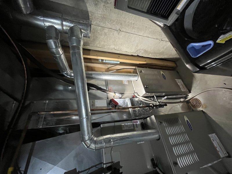 Responded to service call for non-functioning thermostat on second-floor unit over 10 years old. Upon inspection, diagnosed complete thermostat failure with no display or power. Performed system evaluation of existing HVAC equipment including furnace, air handler, and associated ductwork in basement installation. Documented equipment condition and electrical connections for diagnostic purposes. Provided customer with repair options and recommendations for thermostat replacement to restore system functionality.