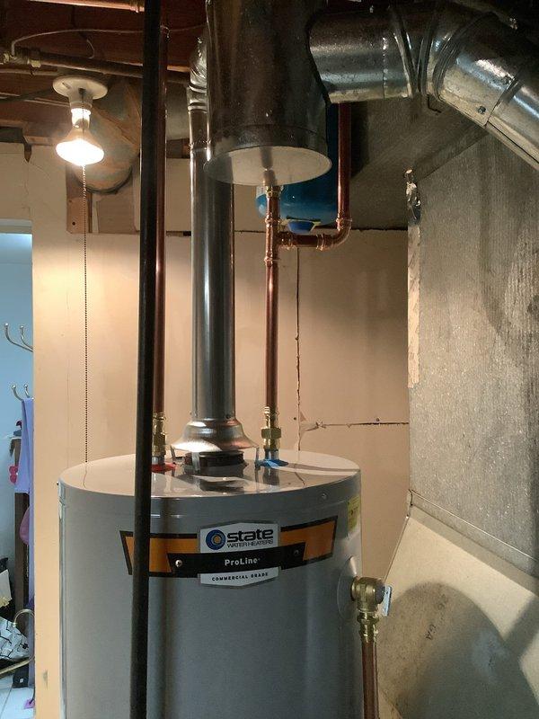 Installed a 40-gallon tall gas water heater with 3/4" pressure reducing valve in compliance with City of Ballwin permit requirements. Connected gas line, water supply, and venting system with proper fittings and supports. Additionally replaced customer-supplied garbage disposal unit and reworked tubular drain assembly under kitchen sink to accommodate new fixture installation.