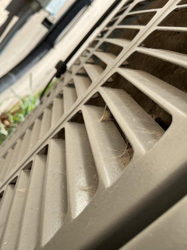 Responded to thermostat error code indicating low secondary 24 VAC voltage on hallway unit U10. Performed diagnostic inspection of HVAC system, checking electrical connections, transformer output, and control circuit voltage levels in confined attic space. Inspected outdoor condenser unit, noting accumulated dirt and debris on coil fins that could impact system efficiency and airflow, documenting conditions with photographs for service records.