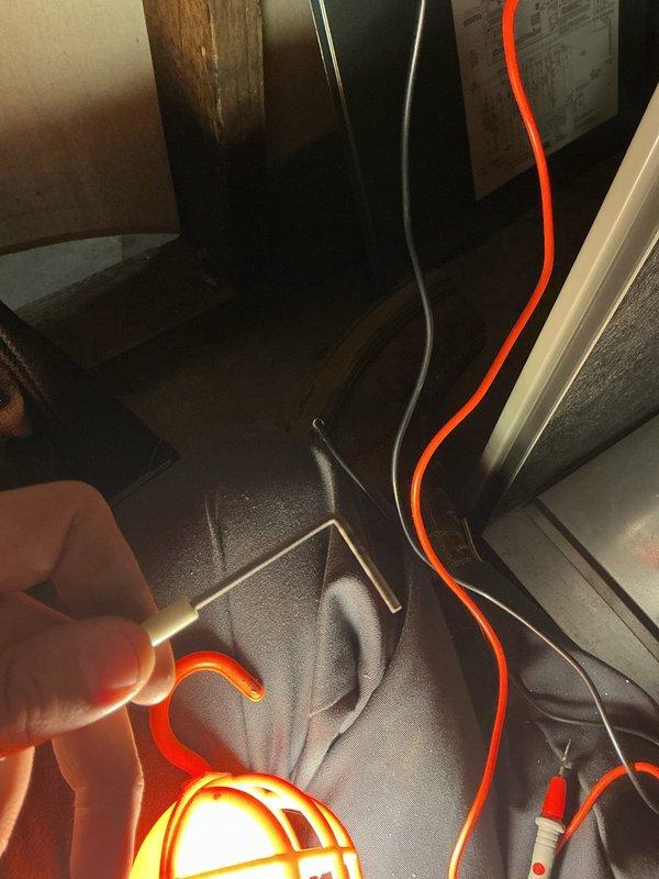 Responded to thermostat error code indicating low secondary 24 VAC voltage on hallway unit U10. Performed diagnostic inspection of HVAC system, checking electrical connections, transformer output, and control circuit voltage levels in confined attic space. Inspected outdoor condenser unit, noting accumulated dirt and debris on coil fins that could impact system efficiency and airflow, documenting conditions with photographs for service records.