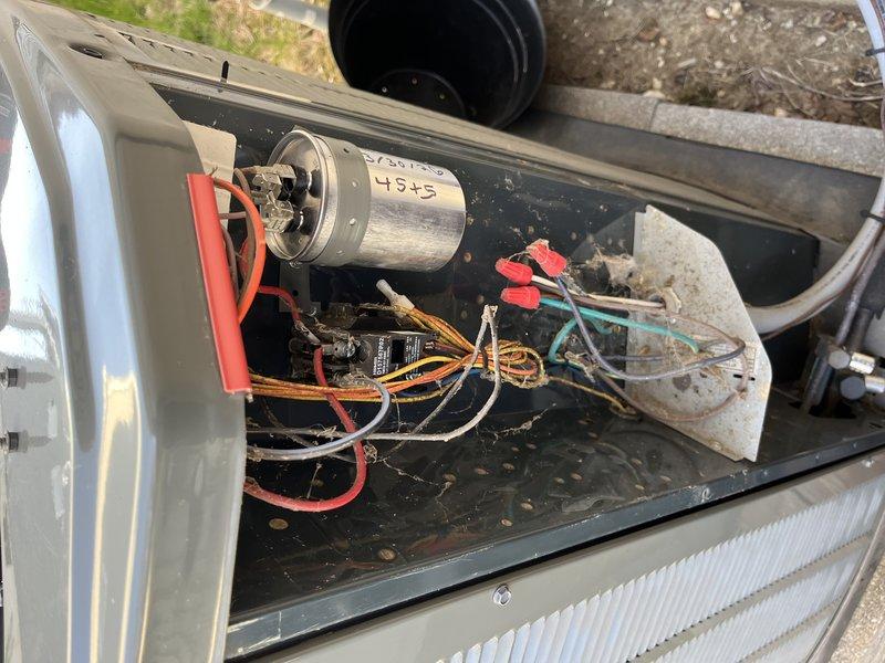 Responded to no cooling complaint on residential split system under 10 years old located in side yard. Upon inspection, found unit blowing warm air as reported. Accessed condensing unit compartment and observed significant debris accumulation including leaves and dirt in base pan. Tested capacitor marked 4545 using Fluke T6-600 electrical tester and confirmed failed dual run capacitor with low microfarad reading of 0.3. Replaced defective capacitor with properly rated unit, verified all electrical connections secure, and tested system operation. Unit now cooling properly with normal amperage draw and temperature split across evaporator coil.