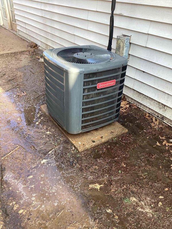 # HVAC Cooling System Tune-Up Completed

Performed comprehensive seasonal cooling tune-up on single Goodman brand condenser unit located in backyard. Unit positioned on concrete pad against exterior wall with standard electrical conduit and PVC condensate drain line installation.

## Work Performed

Conducted complete system inspection and preventive maintenance protocol. Evaluated condenser unit exterior condition, noting operational placement on concrete pad with adequate clearance. Inspected electrical connections including visible wiring runs - verified secure terminations and proper insulation integrity on all conductor pathways. 

Assessed refrigerant line connections and condensate drainage system functionality. PVC drain line routing confirmed appropriate for proper moisture evacuation. Examined fan motor assembly through top guard, verifying secure mounting and operational readiness.

Cleaned condenser coil surfaces and removed accumulated debris from unit perimeter and housin