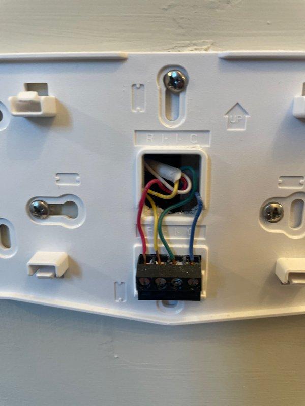 Responded to service call for thermostat displaying blank screen. Upon arrival, performed diagnostic evaluation of Lennox digital thermostat and wiring connections. Removed thermostat from wall plate to inspect terminal block and verify proper wire connections including R, Y, G, and W terminals. Found loose wire connection causing intermittent power loss to display. Secured all wiring connections at terminal block, reinstalled thermostat to wall plate, and restored power. Verified thermostat display functioning properly with temperature reading of 73°F, system status indicators operational, and heating/cooling setpoints responding correctly. Tested system communication and confirmed full functionality. Unit operational at time of departure.