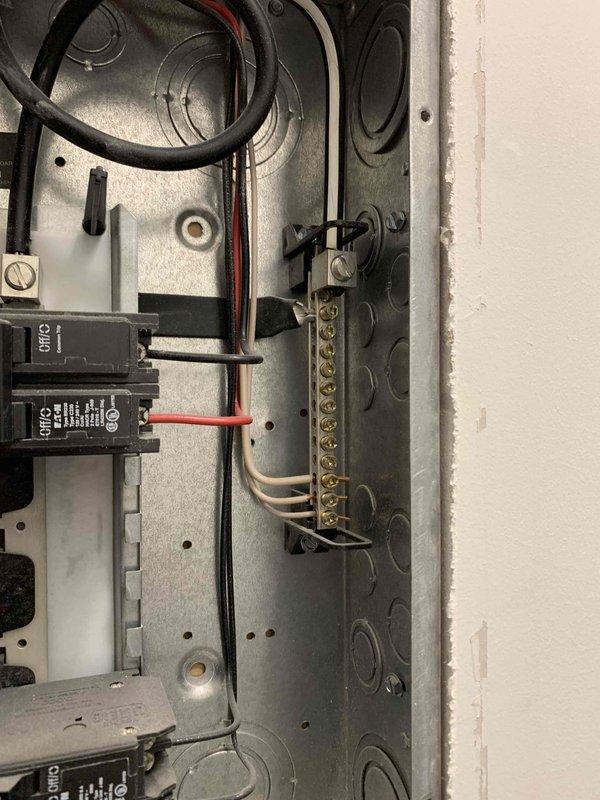 Completed comprehensive electrical inspection of residential property, focusing on main electrical panel and utility space conditions. Evaluated circuit breaker configuration, wire connections, and grounding system within the main distribution panel, noting proper wire routing and terminal connections. Documented moisture damage to ceiling surfaces in mechanical space and assessed potential impact on electrical infrastructure, including exposed wiring bundles and copper plumbing lines in proximity to electrical components. Inspected outlet functionality and verified proper grounding connections throughout affected areas.