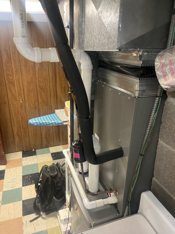 Replaced defective evaporator coil in residential air handler system due to no cooling condition. Installed two 2-inch PVC couplings for condensate drain line connections. Evacuated system, charged with refrigerant to manufacturer specifications, and verified proper operating pressures and temperatures using manifold gauges. Confirmed system cooling operation and proper airflow upon completion.