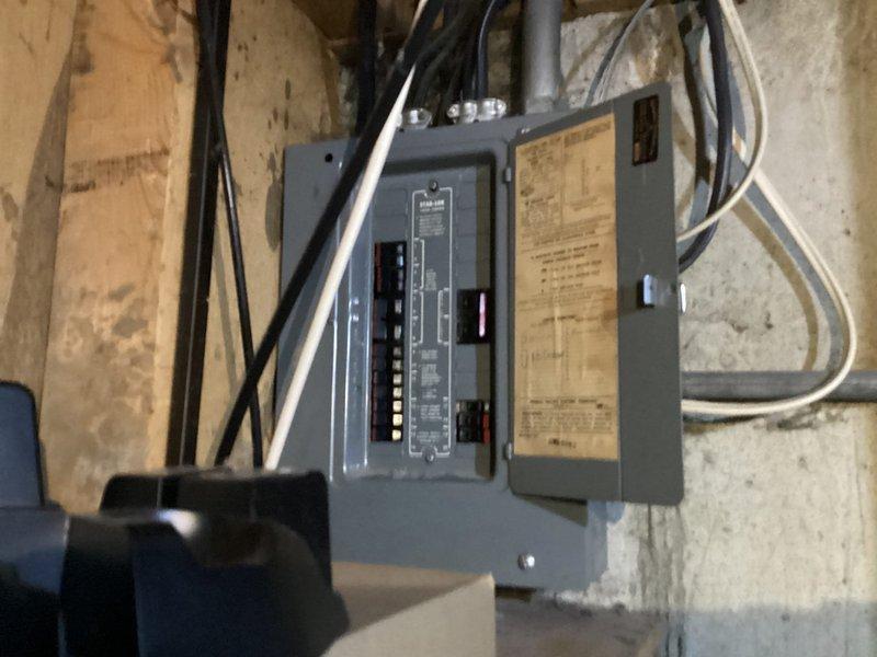 Completed comprehensive electrical inspection of residential main service panel and subpanel installation in basement utility area. Documented existing electrical infrastructure including main breaker panel with multiple circuit breakers, associated subpanel, and all incoming/outgoing electrical cables and conduit runs. Photographed panel configuration, wire routing, circuit directory labeling, and overall installation condition for record-keeping purposes.