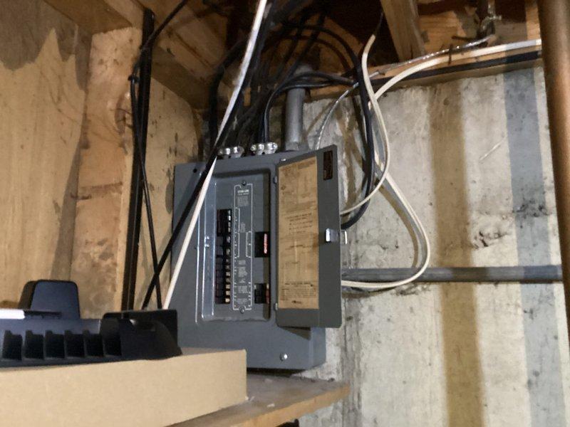 Completed comprehensive electrical inspection of residential main service panel and subpanel installation in basement utility area. Documented existing electrical infrastructure including main breaker panel with multiple circuit breakers, associated subpanel, and all incoming/outgoing electrical cables and conduit runs. Photographed panel configuration, wire routing, circuit directory labeling, and overall installation condition for record-keeping purposes.