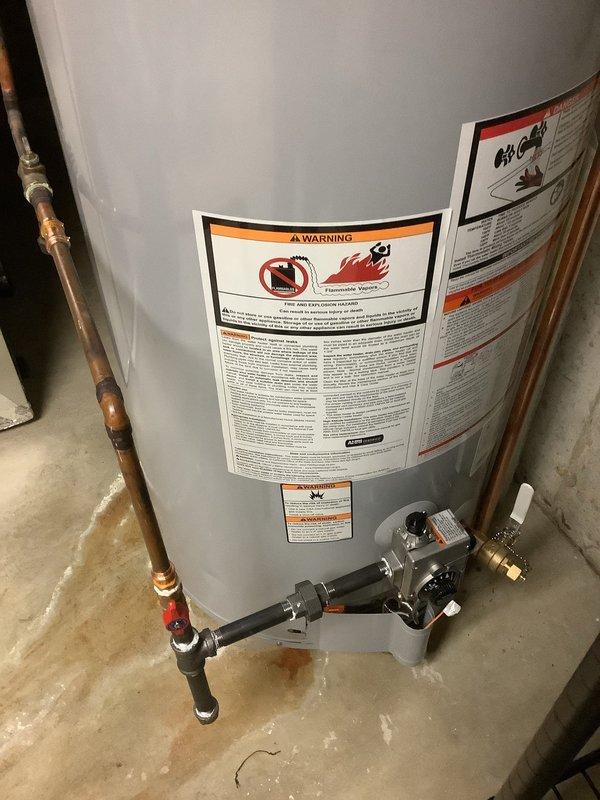 Installed a 50-gallon tall gas water heater in basement utility area with copper supply line connections and proper venting. Checked water pressure throughout the home to determine if a pressure reducing valve (PRV) installation was necessary. All connections secured with appropriate brass fittings, gas valve assembly installed at base, and pressure relief valve properly positioned per code requirements.