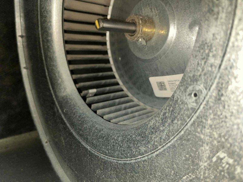 Performed comprehensive cooling season tune-up on 8-year-old residential air conditioning unit. Inspected and photographed blower wheel assembly, noting moderate dust accumulation on squirrel cage blower and housing components; verified motor shaft coupling and hardware secure. Evaluated air filtration system, confirmed proper installation of clean pleated media filter in crosshatch frame. Completed standard maintenance protocols including system performance verification and operational testing of all cooling components.