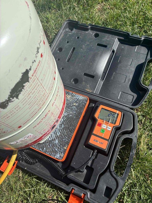 Responded to callback for newly installed AC unit experiencing short cycling. Upon arrival, performed diagnostic testing of the system using digital multimeter. Verified unit was powering on briefly before shutting down. Inspected outdoor condensing unit and confirmed proper equipment identification and labeling. Conducted voltage and amperage readings which displayed 25 on meter during testing. Documented equipment serial number and system components with photos for service records. Troubleshot electrical connections and system controls to identify root cause of premature shutdown issue. Resolved short cycling condition and verified system operation returned to normal parameters.