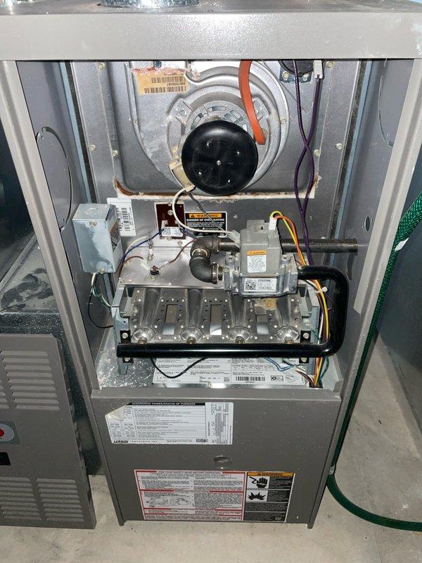 Responded to call for water leaking from furnace during air conditioning operation. Upon inspection, identified clogged condensate drain line as source of water leakage. Cleared blockage from drain line and verified proper drainage flow. Noted significant debris accumulation in outdoor unit cabinet and rust present on capacitor housing. Cleaned debris from base of equipment and checked all electrical connections. Tested system operation to confirm AC cooling cycle running properly with no further water leakage. Discussed preventative maintenance agreement options with customer to address ongoing equipment maintenance needs and prevent future service issues.