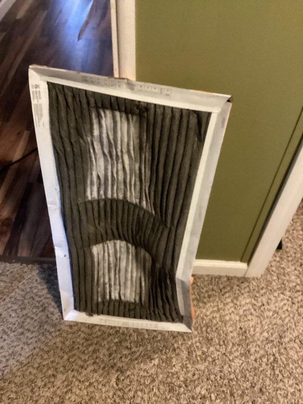 Completed comprehensive cooling system tune-up on 10-year-old outdoor AC unit located in front yard. Performed standard preventive maintenance including system inspection, refrigerant level check, electrical connection testing, condenser coil cleaning, and operational verification. Discovered and documented severely clogged air filter with excessive dirt and debris accumulation, which was restricting airflow and reducing system efficiency. Inspected ductwork opening and noted dust buildup on insulation surfaces near return air pathway. Replaced dirty filter and advised homeowner on proper maintenance intervals to prevent future airflow restrictions and maintain optimal system performance.