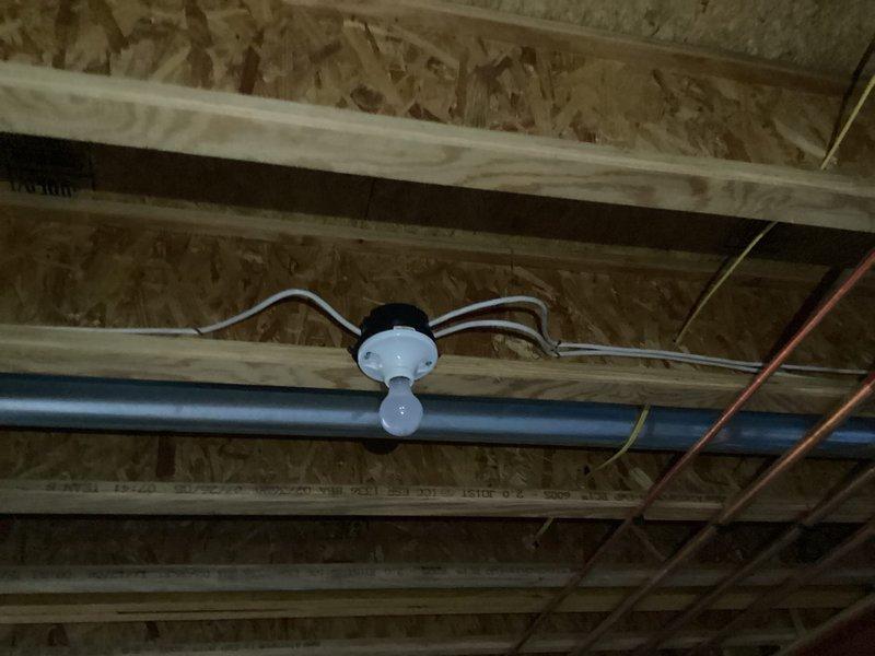 Completed comprehensive electrical inspection of unfinished ceiling space, documenting exposed electrical systems including yellow Romex wiring, junction boxes, and conduit routing through ceiling joists. Photographed existing MEP installations showing copper plumbing, PVC piping, and electrical distribution to verify proper installation methods and identify any code compliance concerns for homeowner records.