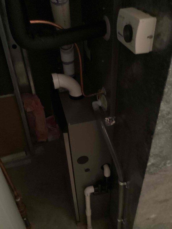 Responded to service call for cooling system not maintaining set temperature on 10+ year old unit located in sideyard. Performed system inspection and diagnostics on air handler and condensate drainage system. Evaluated thermostat operation and confirmed proper communication with HVAC equipment. Documented system condition with photos showing air handler cabinet access, PVC condensate lines, and Honeywell digital thermostat installation.